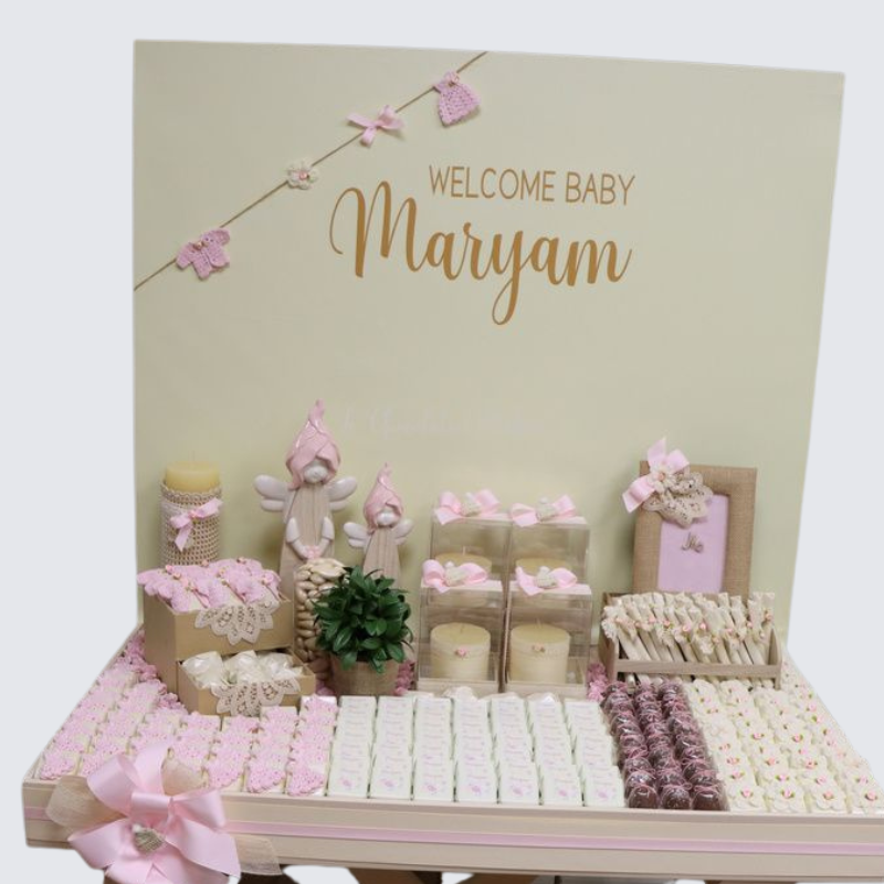 Baby crochet decorated and personalized chocolate wood stand with personalized backdrop.