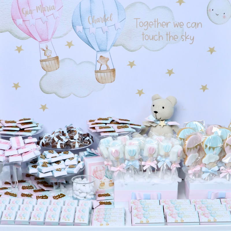 Baby twin designed air balloon theme chocolate arrangement stand with personalized backdrop.