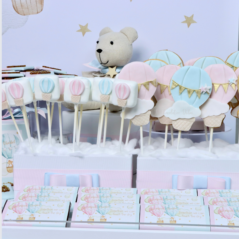 Baby twin designed air balloon theme chocolate arrangement stand with personalized backdrop.