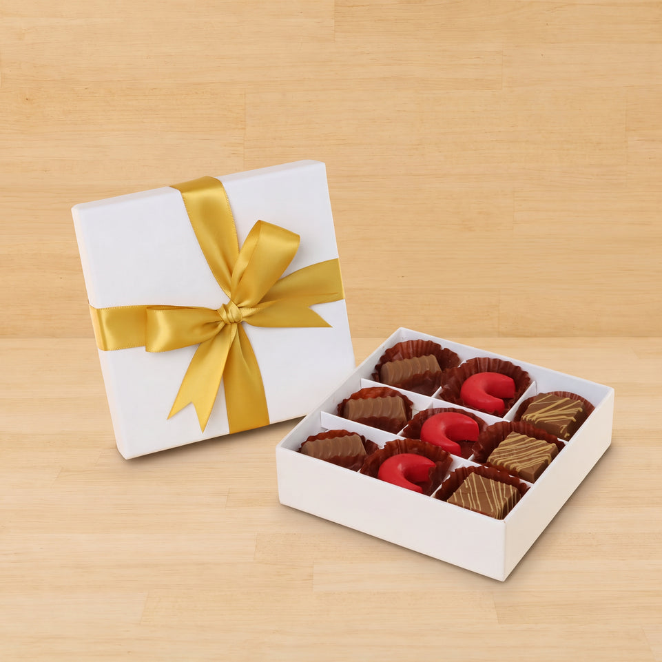 Premium chocolate 9-pc white hard box with gold ribbon