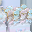 Baby twin designed air balloon theme chocolate arrangement stand with personalized backdrop.