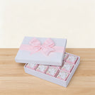 Welcome baby girl flower designed 12-piece chocolate hard box