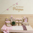 Baby crochet decorated and personalized chocolate wood stand with personalized backdrop.