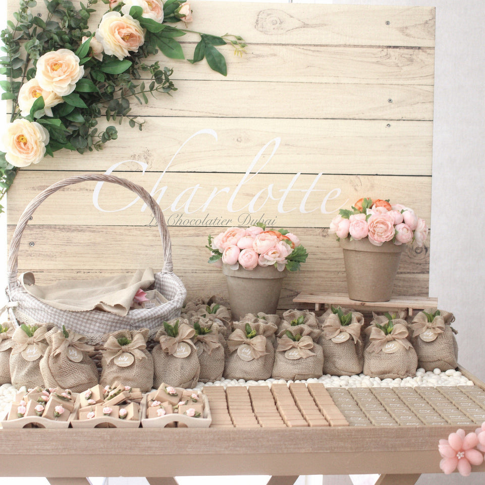 Baby girl rustic floral chocolate wood stand with personalized backdrop.