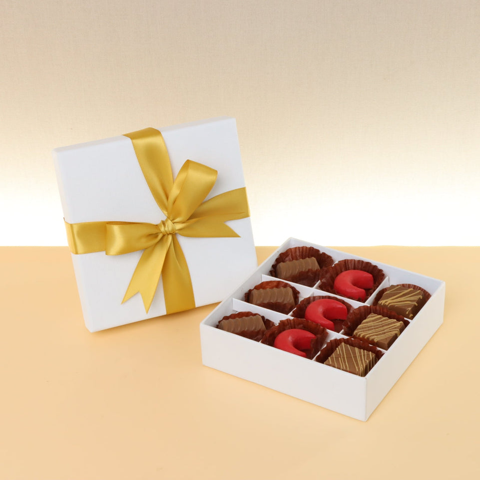 Premium chocolate 9-pc white hard box with gold ribbon