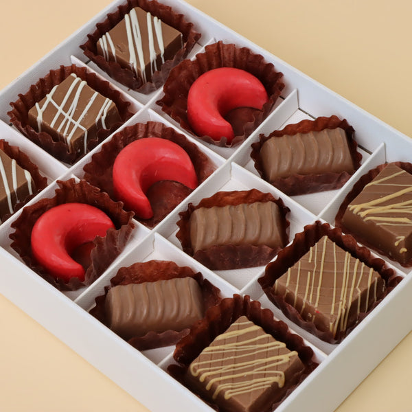 Premium chocolate 12-pc white hard box with gold ribbon