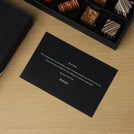 Corporate customized premium chocolate 42P hard box with top card.