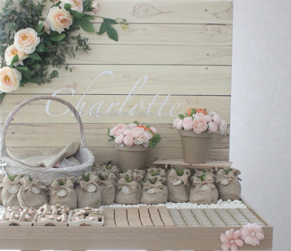 Baby girl rustic floral chocolate wood stand with personalized backdrop.
