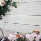 Baby girl rustic floral chocolate wood stand with personalized backdrop.