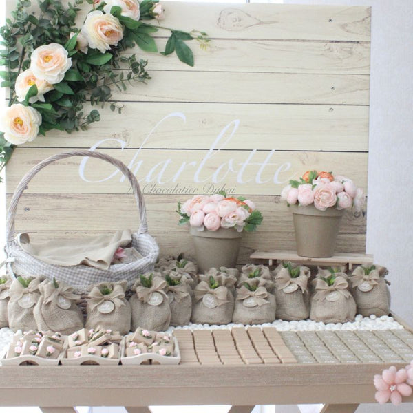 Baby girl rustic floral chocolate wood stand with personalized backdrop.